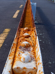 Along a rusty metal railing