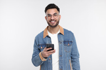 Happy young man using smartphone on white background