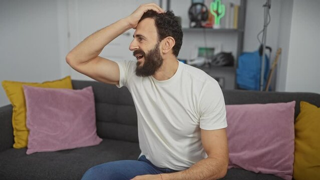 Oops! middle aged man in white t-shirt at home slaps hand on head, regrets foolish mistake. frustrated, he forgot, realized his memory error. indoor blunder causes stress.