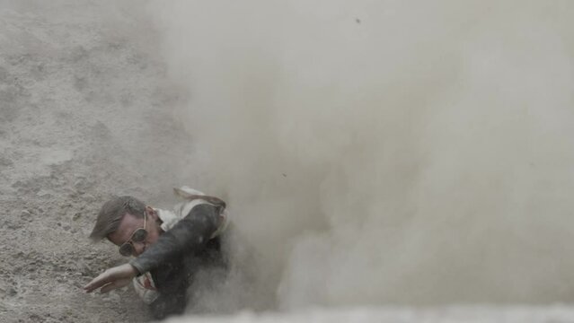 Stunt man in slow motion dust explosion
