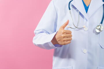 Thumb up, Close up female medical doctor isolated on pink background.