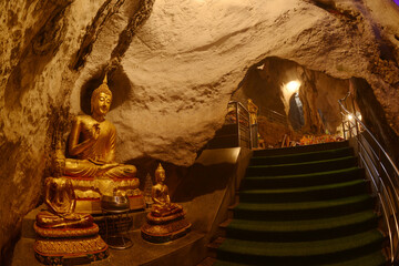 Buddha statues in various postures Enshrined in the famous Tham Khao Yoi Temple. And there are...