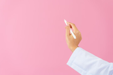 Close up female medical doctor isolated on pink background.