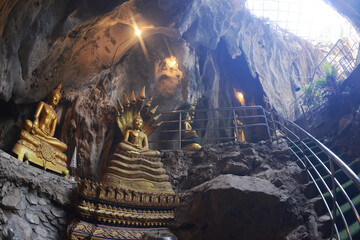 Buddha statues in various postures Enshrined in the famous Tham Khao Yoi Temple. And there are beautiful stalagmites and stalactites. Located at Petchaburi Province in Thailand.