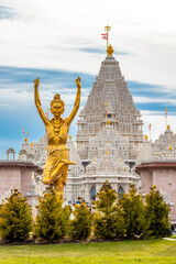 Statue of Nilkanth Varni with Akshardham Mahamandir temple in the back