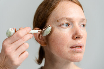 A woman does a facial massage