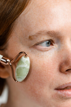 A woman does a facial massage