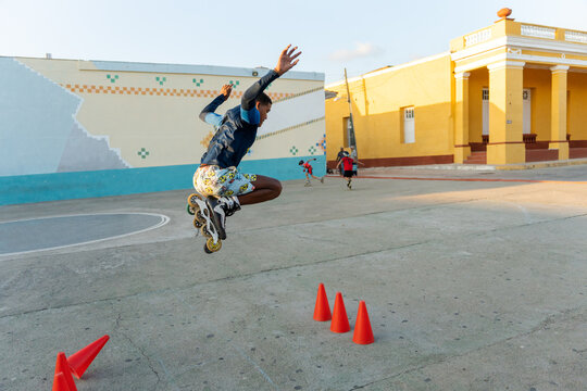 Black Hispanic Boy Roller Skating Outdoors.