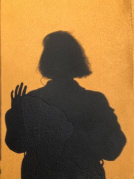POV shadow of a woman saying hello