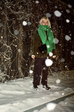 z generation blond girl in the snow during a snowstorm winter night