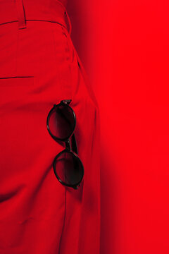 Close-up of a person wearing c trousers and sunglasses