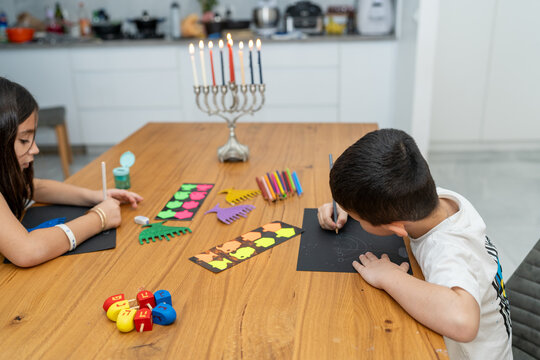 Hanukkah Card Crafting. Kid's Creativity Illuminated by Menorah Flames