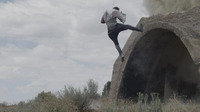 Explosion and stunt man flying through the air in slow motion