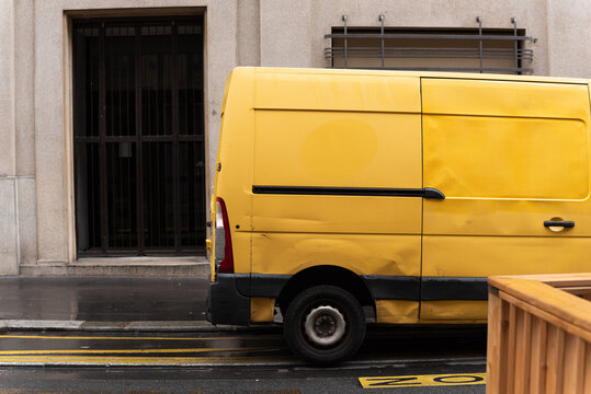 Yellow van parked near the European building