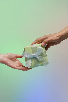 Hands giving and receiving a present