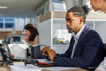 Businessman making reports while discussing with female professional
