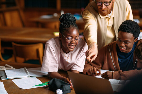 Happy students in class learning together
