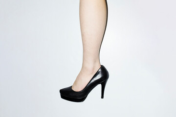 Woman with shin hair wearing heels. Image normalizing female body hair