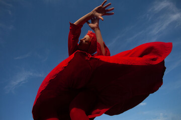 A girl is dancing in red 