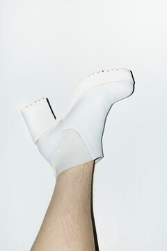 Woman with shin hair wearing boots. Image normalizing female body hair