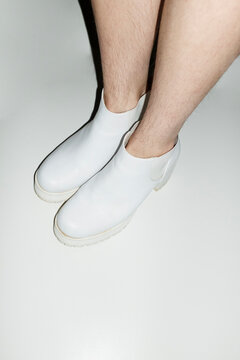 Woman with shin hair wearing boots. Image normalizing female body hair