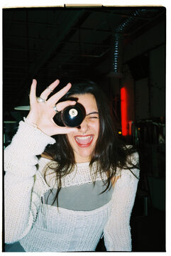 woman posing with billiard ball