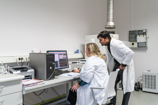 Two Researchers Working Together In The Lab 