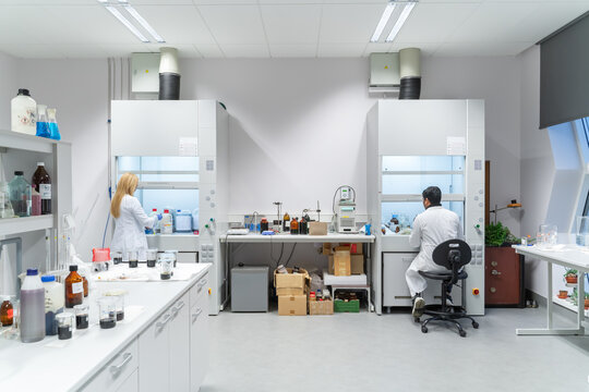 Scientists Working In Chambers In Catalysis Lab