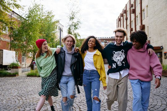 Cheerful friends walking down the street