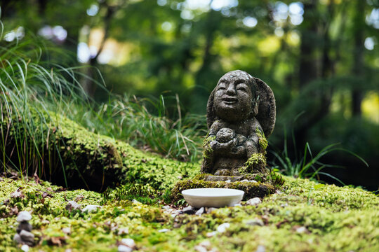 Stone Jizo Statue in Mossy Garden