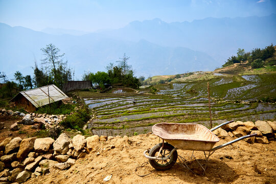 North Vietnam rice paddy terrace smallholding, rest break in heat 