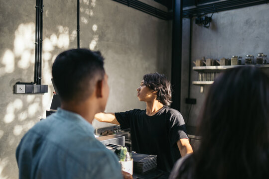 Customers ordering at the counter of a cafe