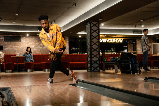 A man is playing bowling