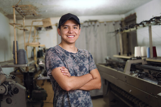 Man smiling in his textile workshop