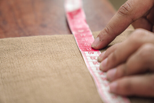Man measuring cloth