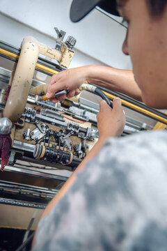 Man cleaning a textile machine