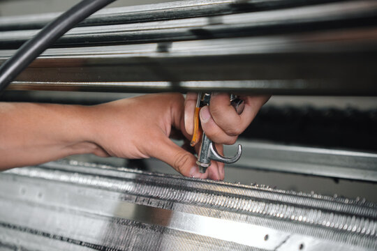 Man cleaning a textile machine