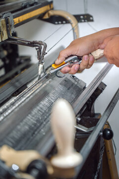 Man cleaning a textile machine
