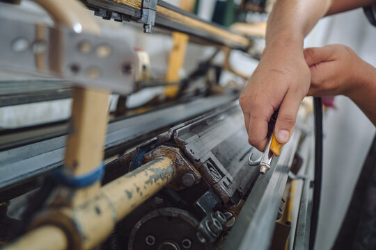 Man cleaning a textile machine