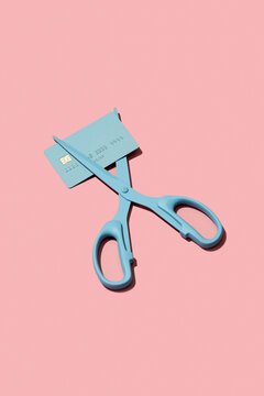 Scissors cutting debit / credit card. Reduce / pay off debt concept.