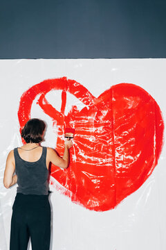 Man painting heart