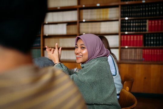 Teens studying together in library