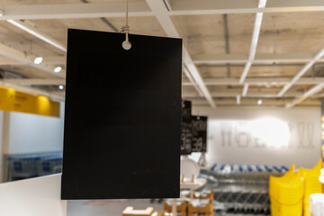 Mockup blank banner hanging from ceiling in selling kitchenware shop
