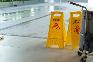 Two Yellow caution wet floor sign on Wet floor