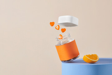 Plastic bottle with gummy  jumping out and citrus fruits