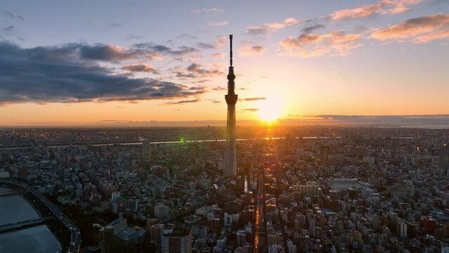 Aerial view of Tokyo metropolis and the sun rising over the city skyline.