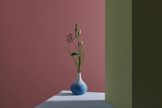 Bouquet of Lisianthus flowers in vase on a table in sunlight. Mockup.