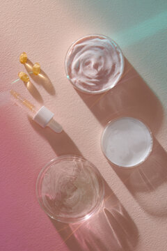 Flat lay composition with Petri dishes on light pink background