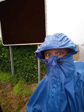 UGC selfie of hiker wearing a raincoat and making silly faces