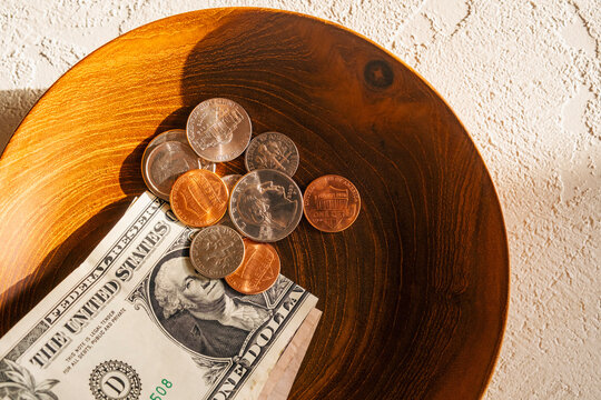 Dollar bill and change in bowl